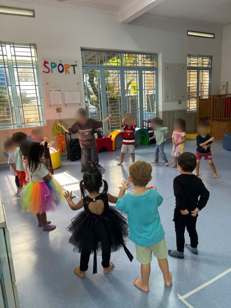 Children in costume dance in the gym