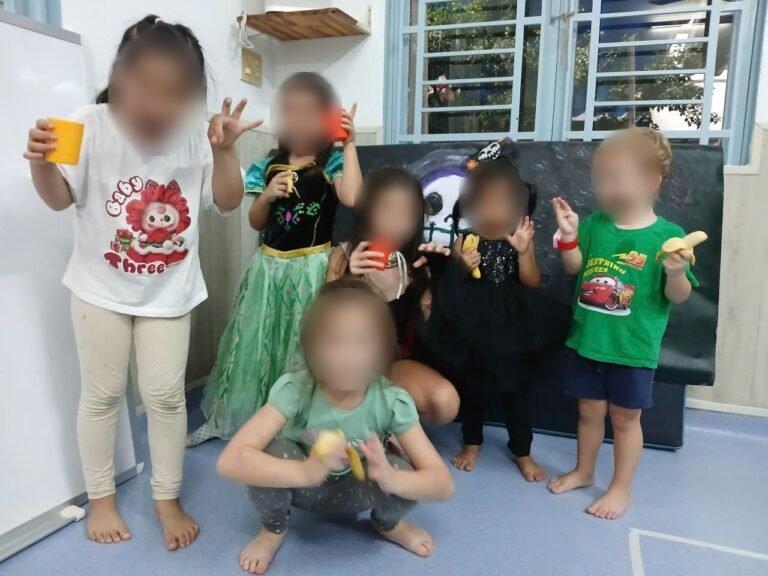 A group of children in costume pull faces for the camera