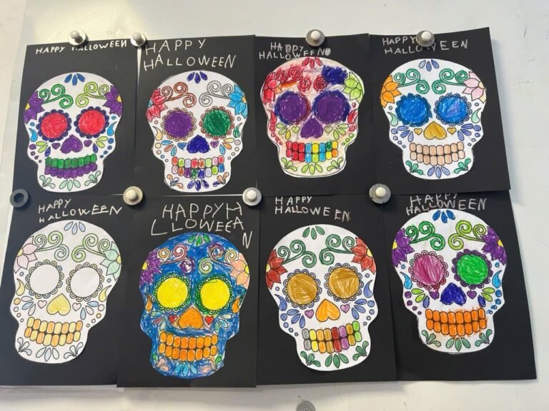 Eight skulls colored in by the children, displayed on the wall