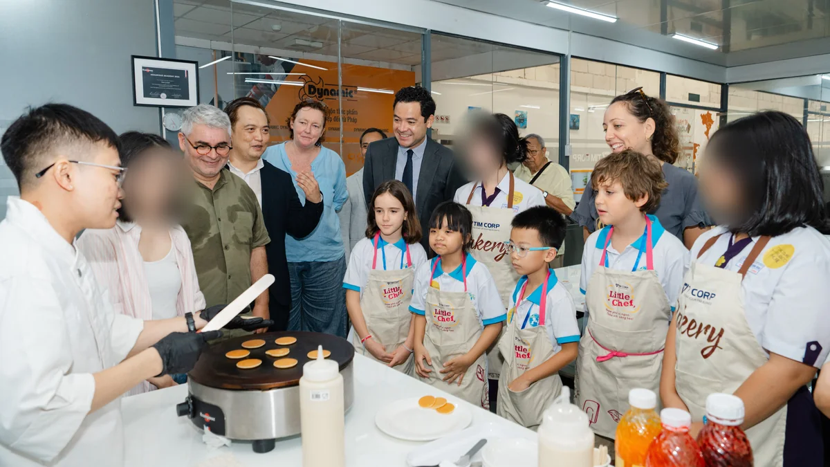 Le Consul général de France Etienne Ranaivoson et nos élèves de CM1 à l'atelier crêpes des Jeux francophones du Goût 2026