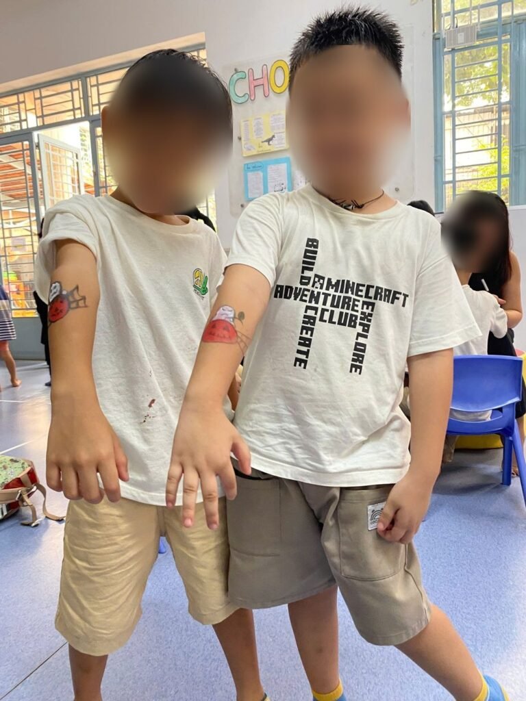 Two boys show the Halloween makeup on their arms